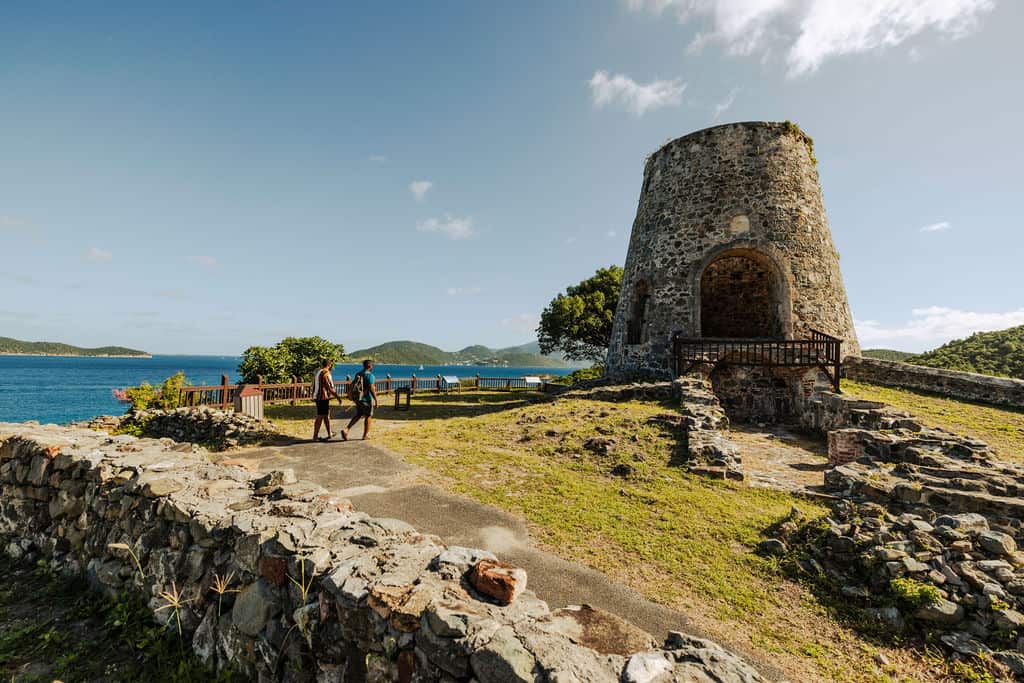 Two people walk toward Annaberg Sugar Plantation ruins, St. John, USVI