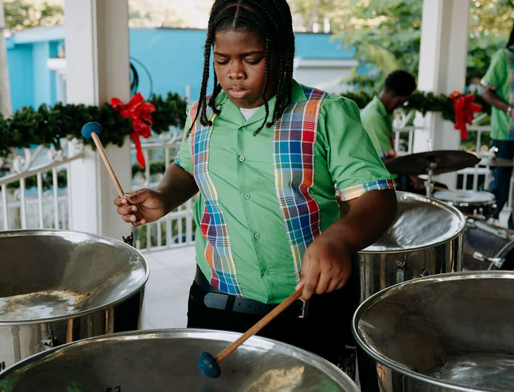 A child plays a steel drum at a cultural performance in USVI