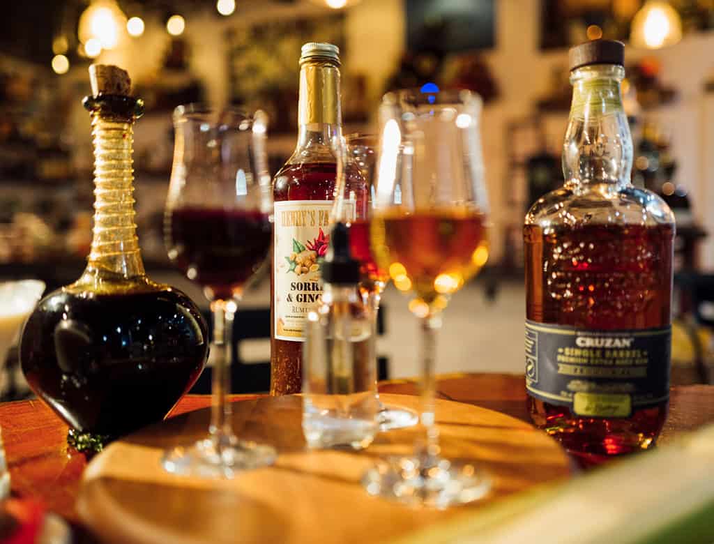 Two glasses of rum sit on a table at a bar on St. Thomas Island