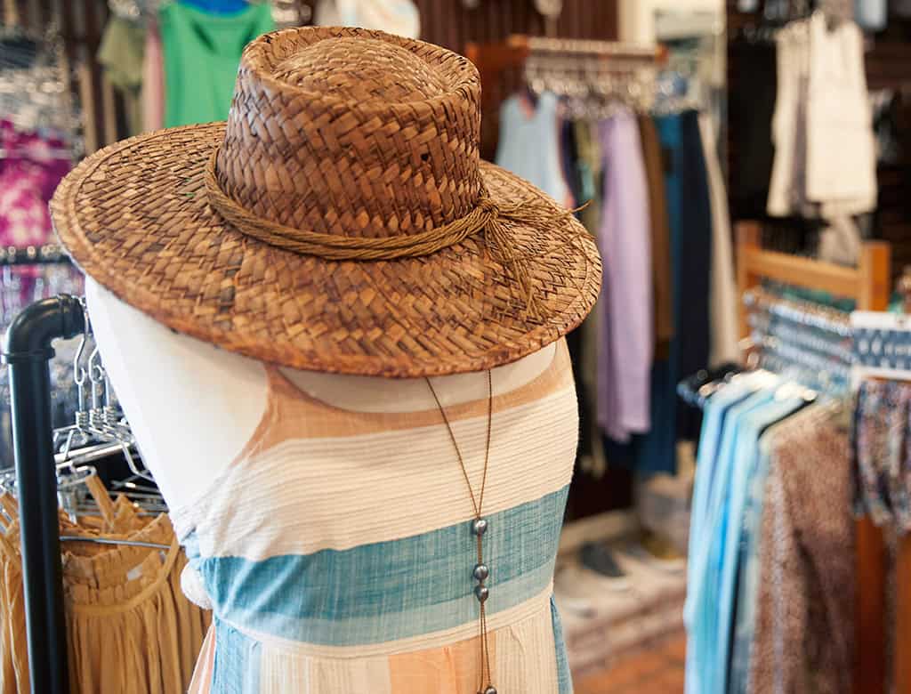A mannequin is wearing a tank top and a hat at a clothing store in USVI