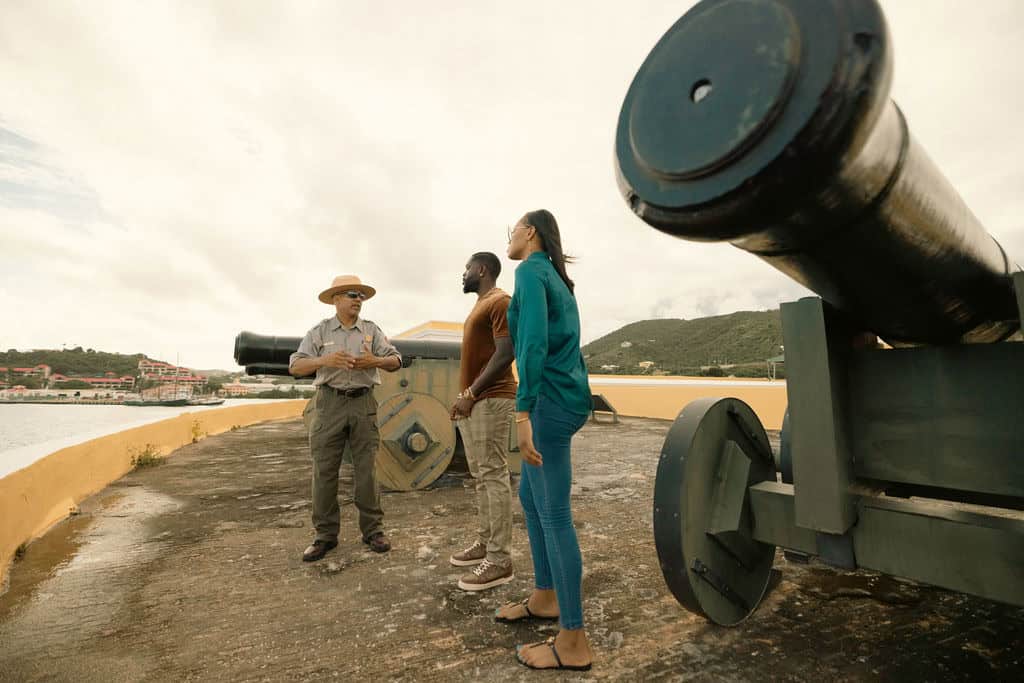 A group is gathered around cannons at Fort Christiansvaern, St. Croix, U.S. Virgin Islands