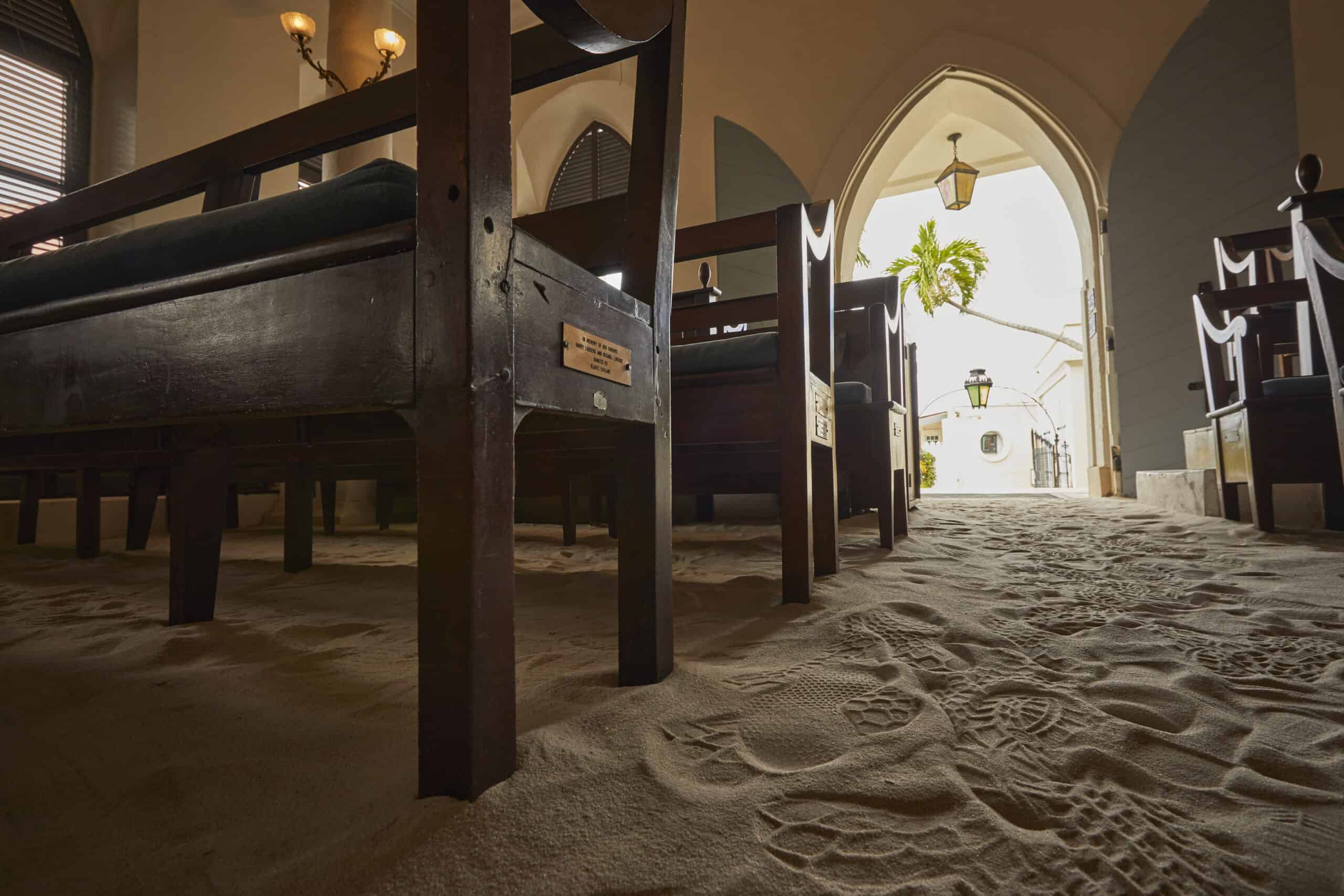 Wooden pews and a sand floor inside The Hebrew Congregation of St. Thomas Synagogue, St. Thomas, USVI