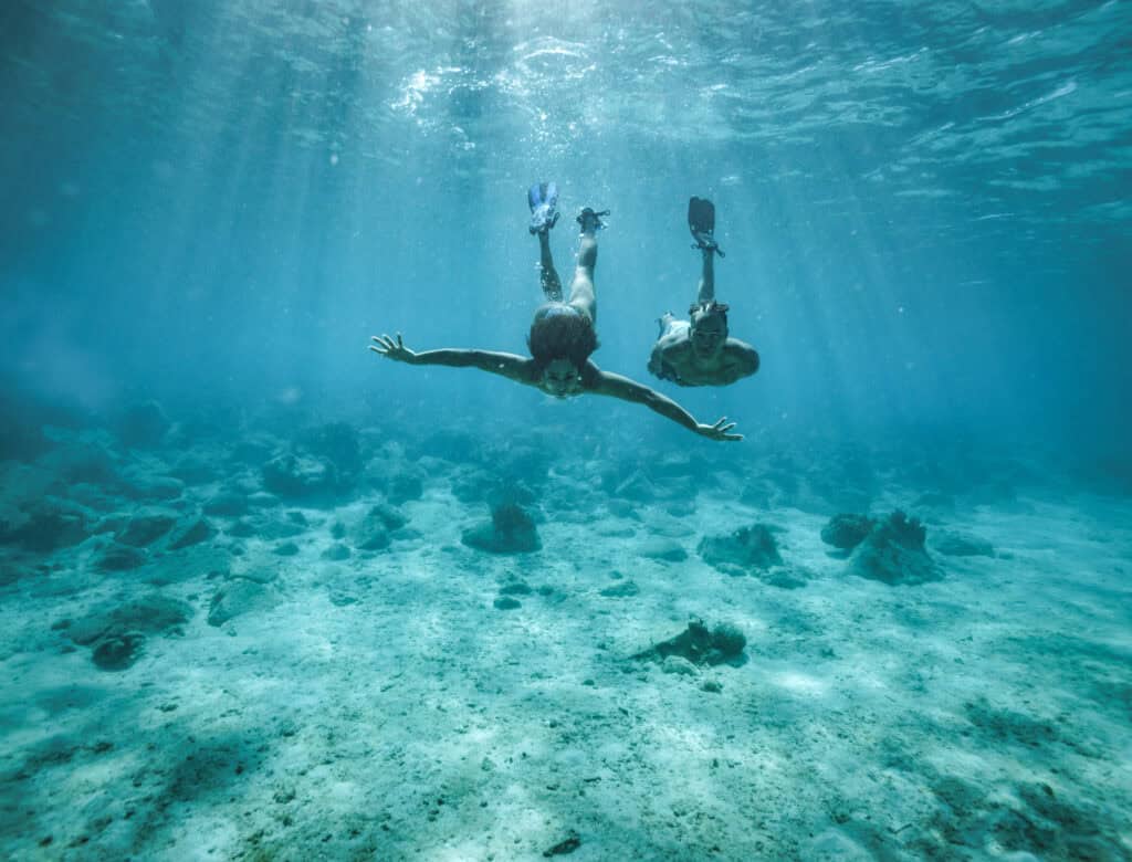 Two people diving underwater off the coast of St. John, USVI.