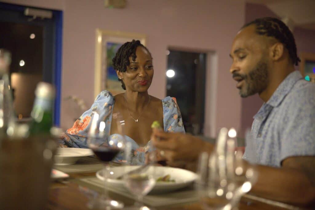 A couple sits at a counter to drink wine and eat an upscale meal at Blue Eleven on St. Thomas in the U.S. Virgin Islands.