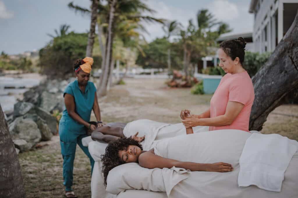 A couple gets massages from two masseuses outdoors at Tamarind Reef Resort, Spa and Marina on St. Croix, U.S. Virgin Islands