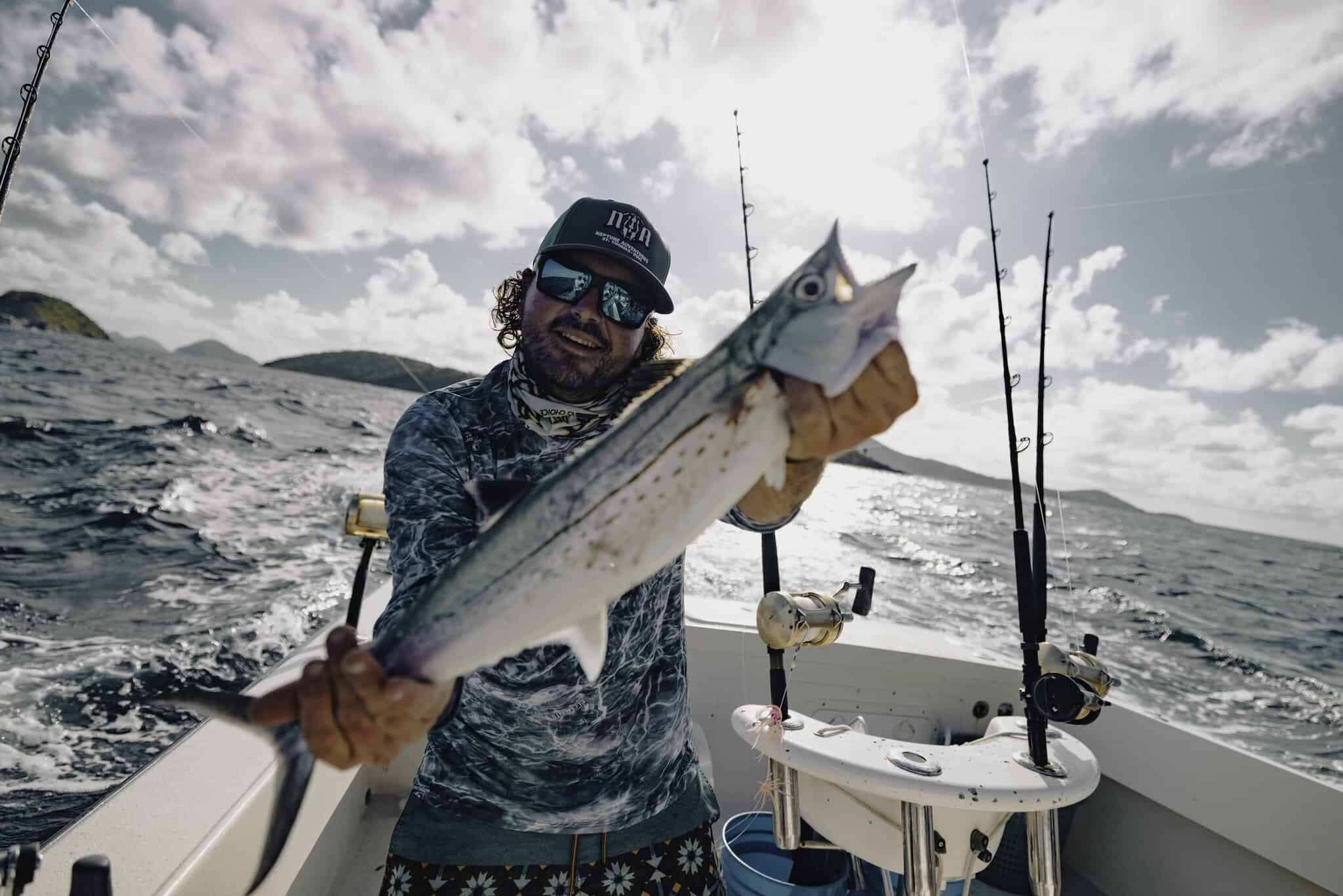 During a charter with Neptune Adventures, a fisherman holds a large fish in his hands while aboard a boat in St. Thomas waters in the U.S. Virgin Islands.