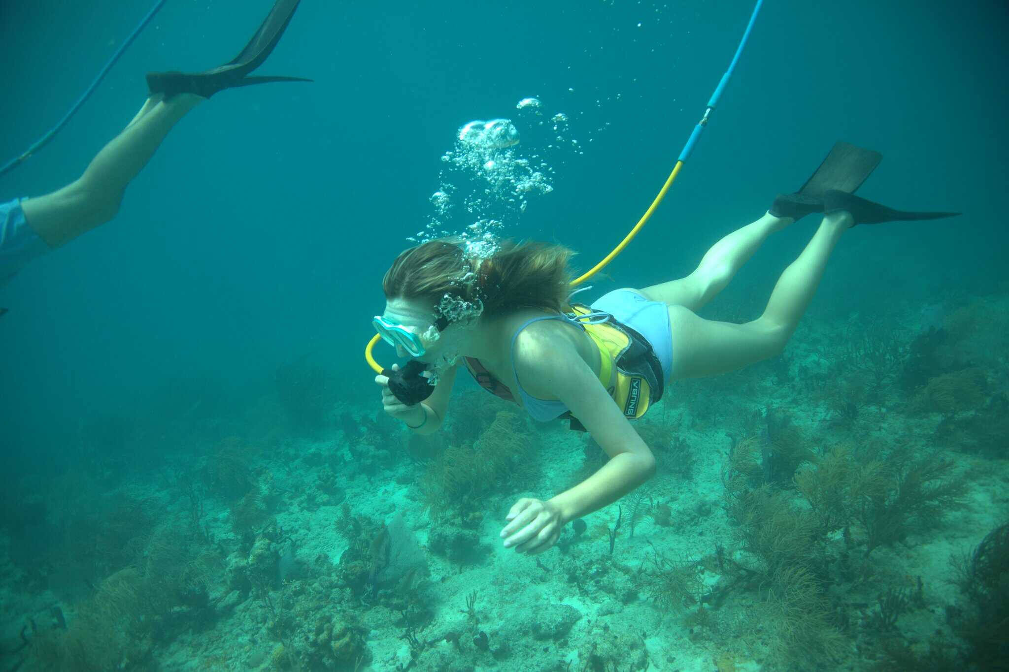 A woman hooked up to an air line snorkels at Coki Point on St. Thomas in the U.S. Virgin Islands.