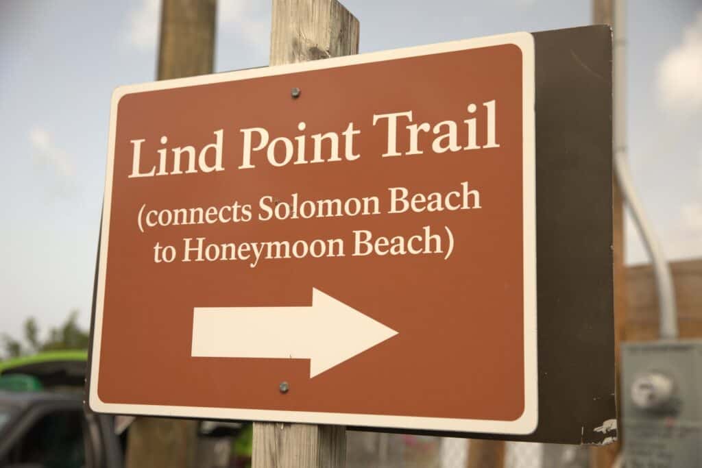 Trail marker on St. John in the  U.S. Virgin Islands  with an arrow showing where Lind Point Trail connects to Solomon Beach and Honeymoon Beach.