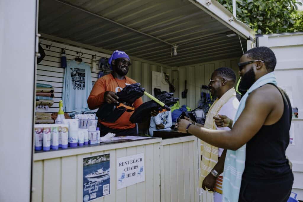 Two men rent snorkeling gear from the vendor at Cinnamon Bay Beach & Campground.