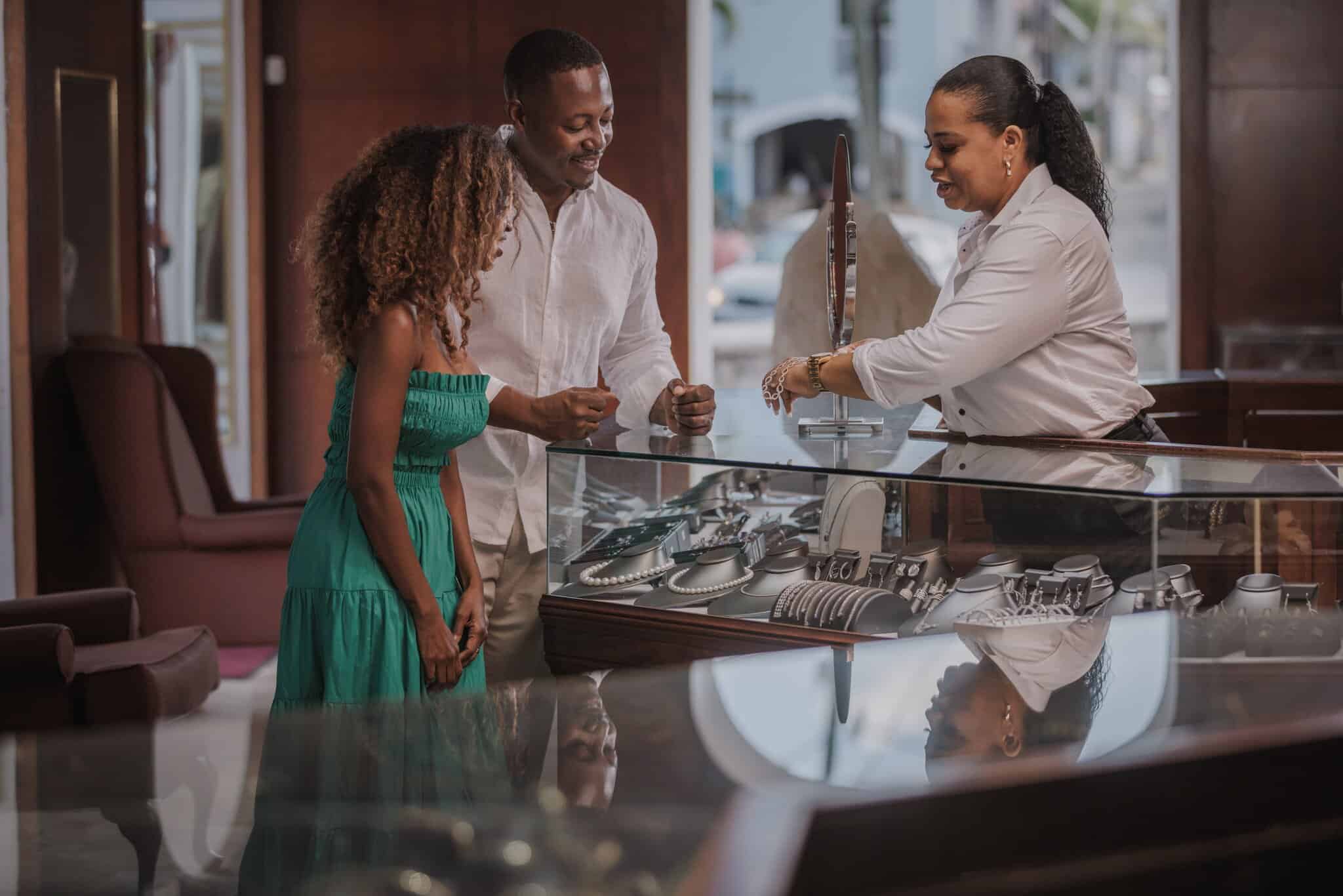A couple stands at the Cardow Jewelers display case while a salesperson behind the counter shows them a bracelet on St. Thomas, U.S. Virgin Islands.